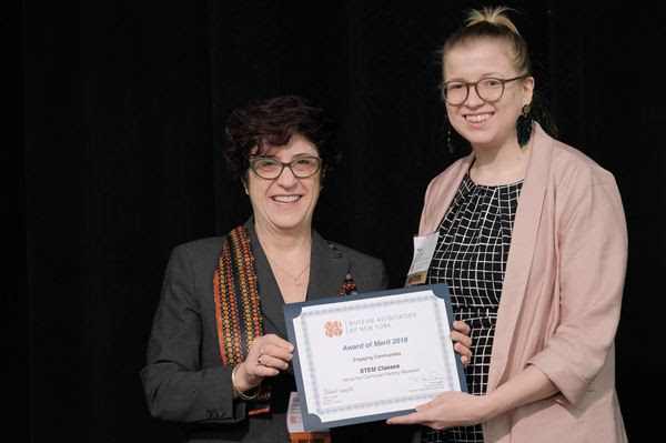 Megan Hahin (right) receiving the Museum Association of New York 's `Engaging Communities` award.
